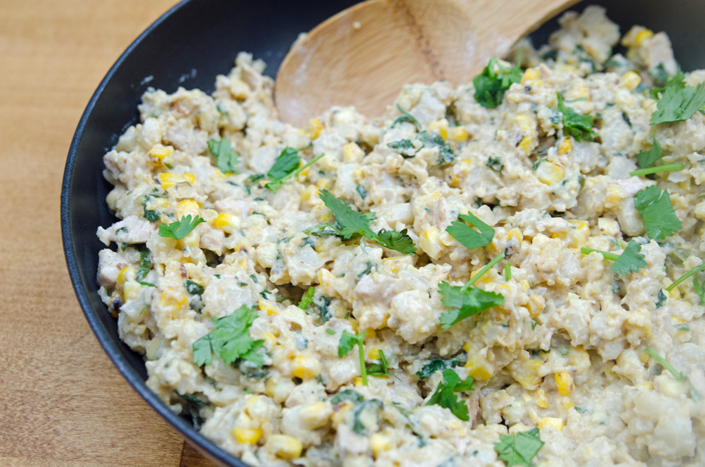 Scooping Creamy Corn Hominy Skillet